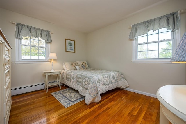 26 Strathmore Dr, New City, NY 10956 - bedroom with baseboards, a baseboard radiator, and wood finished floors