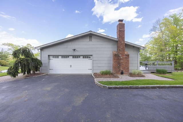 26 Strathmore Dr, New City, NY 10956 - view of side of property with a chimney and driveway