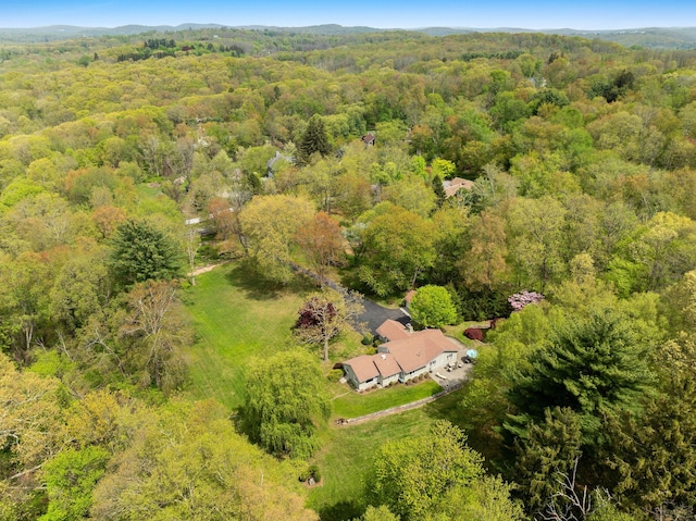 birds eye view of property featuring a view of trees