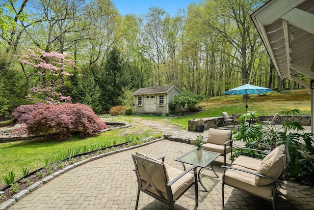 view of patio / terrace featuring a storage unit and an outbuilding
