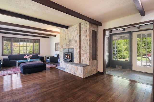 living room featuring a fireplace, beam ceiling, and wood finished floors