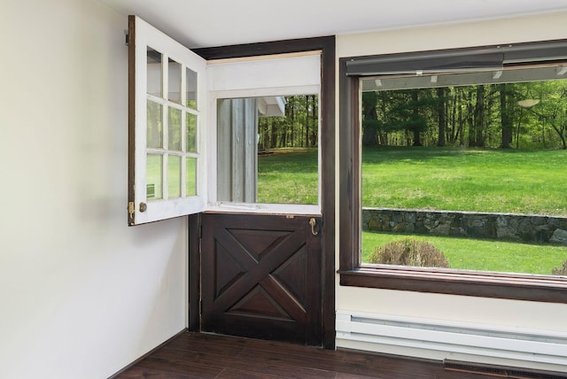 entryway featuring dark wood-type flooring and a baseboard radiator