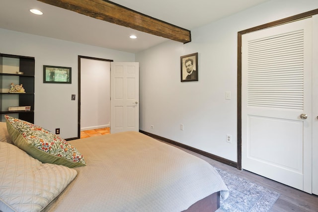 bedroom featuring recessed lighting, wood finished floors, baseboards, and beam ceiling