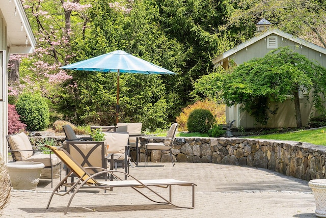view of patio / terrace with a storage shed, a wooden deck, and an outdoor structure