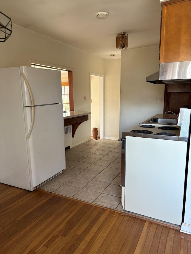 8 Dee Pl, Huntington Station, NY 11746 - kitchen featuring ventilation hood, freestanding refrigerator, radiator heating unit, range with electric stovetop, and light tile patterned floors