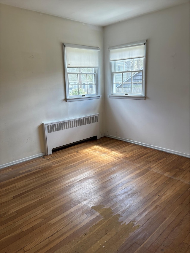 8 Dee Pl, Huntington Station, NY 11746 - unfurnished room featuring radiator heating unit, baseboards, and hardwood / wood-style floors