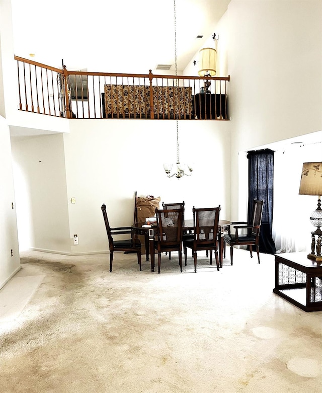 12 Sophia Dr, Middle Island, NY 11953 - carpeted dining space with a high ceiling and a chandelier
