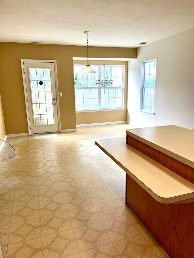 12 Sophia Dr, Middle Island, NY 11953 - unfurnished dining area with light flooring and a chandelier