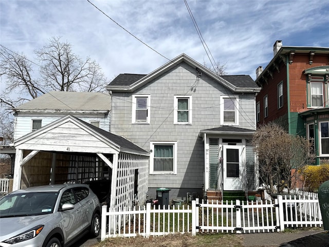 41 William St, Catskill, NY 12414 - view of front of property featuring a shingled roof, fence private yard, and a garage