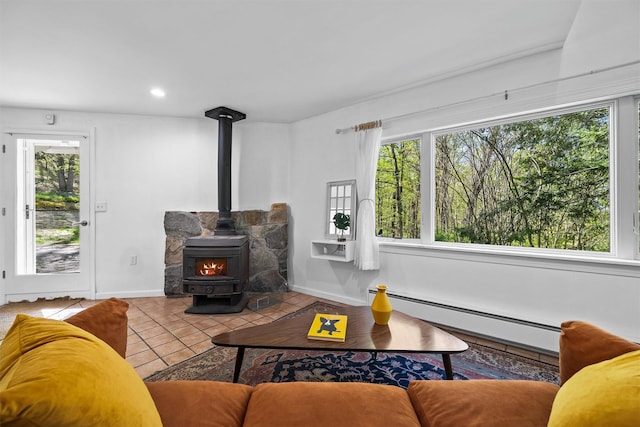 tiled living area featuring a baseboard heating unit, a wood stove, recessed lighting, and baseboards