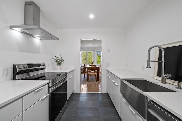 kitchen with dishwasher, modern cabinets, a sink, wall chimney exhaust hood, and electric range