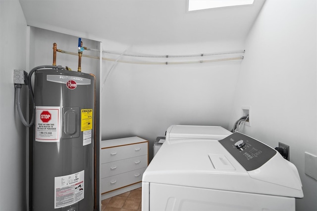 laundry area featuring washer and dryer, laundry area, light tile patterned floors, and water heater