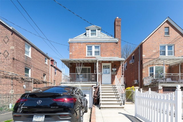 2162 Haight Ave, Bronx, NY 10461 - view of front facade featuring a porch, fence, brick siding, and a chimney