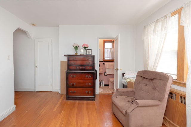 2162 Haight Ave, Bronx, NY 10461 - living area with baseboards, light wood-style floors, and radiator