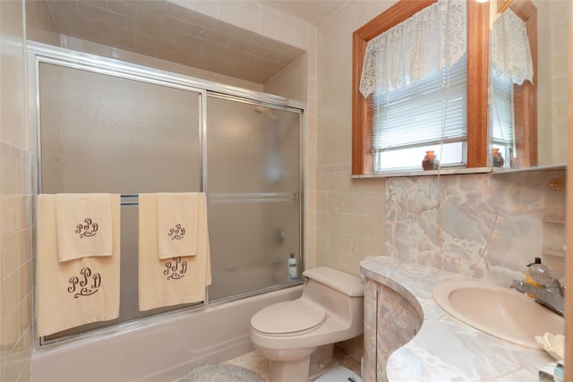 2162 Haight Ave, Bronx, NY 10461 - full bath featuring tile walls, vanity, enclosed tub / shower combo, and toilet