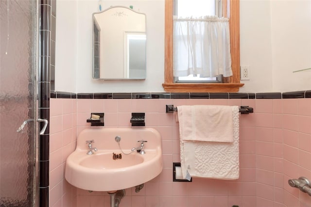 2162 Haight Ave, Bronx, NY 10461 - bathroom with wainscoting, a sink, and tile walls