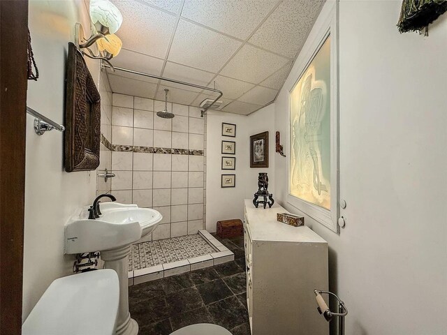 282 Tamerisk Ln, New Windsor, NY 12553 - full bathroom with a tile shower, a drop ceiling, tile walls, and toilet