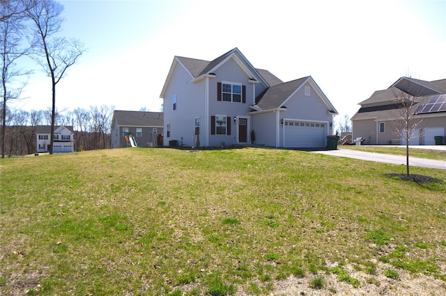 view of front facade featuring an attached garage, driveway, and a front lawn