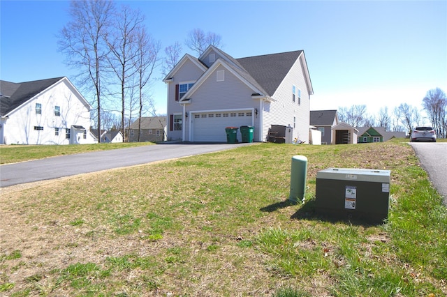 view of property exterior with a garage, aphalt driveway, and a yard