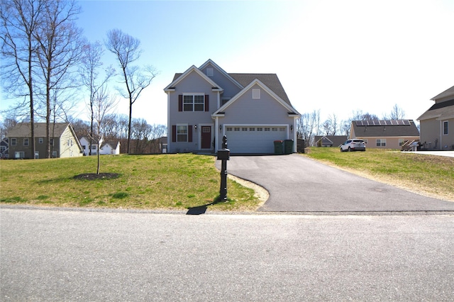 traditional-style house with a front yard and aphalt driveway