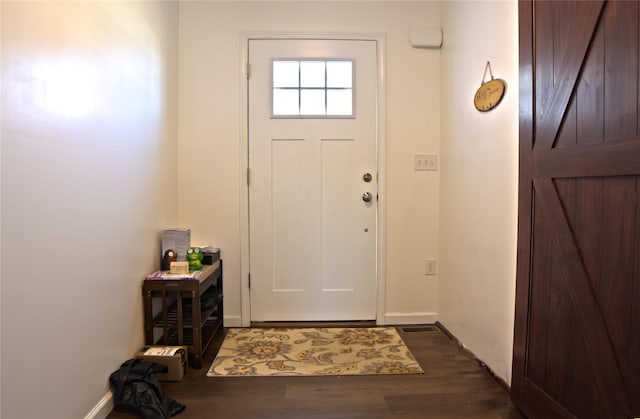 entryway featuring baseboards and dark wood-type flooring