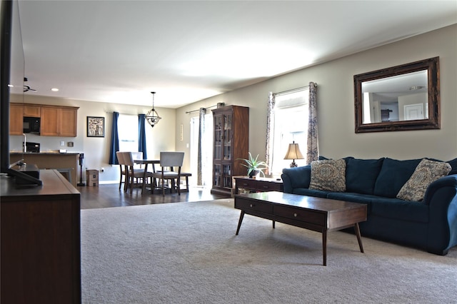 living area featuring recessed lighting and dark carpet