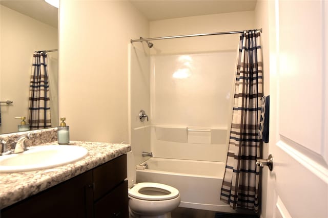 full bathroom with vanity, shower / bath combo, and toilet