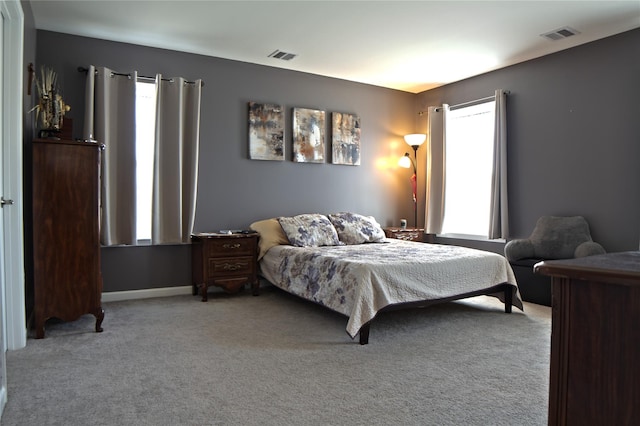 bedroom with visible vents, carpet flooring, and baseboards