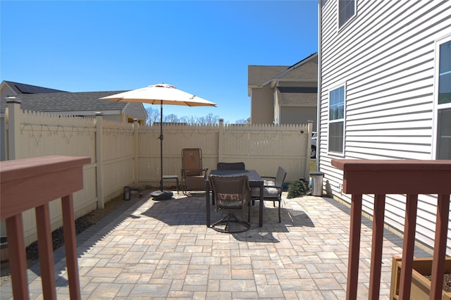 view of patio with outdoor dining area and fence