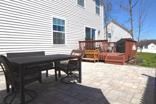 view of patio / terrace featuring a deck, fence, and outdoor dining space