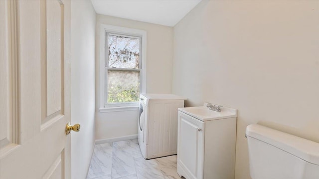 laundry area with marble finish floor, washing machine and dryer, a sink, and laundry area