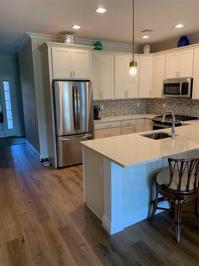 2300 Fox Hill Dr Unit 1101, Baiting Hollow, NY 11933 - kitchen with stainless steel appliances, crown molding, white cabinetry, dark wood-type flooring, and decorative backsplash