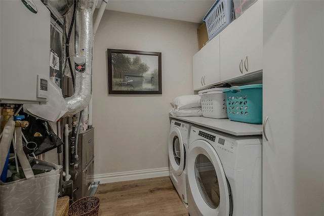 2300 Fox Hill Dr Unit 1101, Baiting Hollow, NY 11933 - laundry room with separate washer and dryer, cabinet space, light wood-type flooring, and baseboards