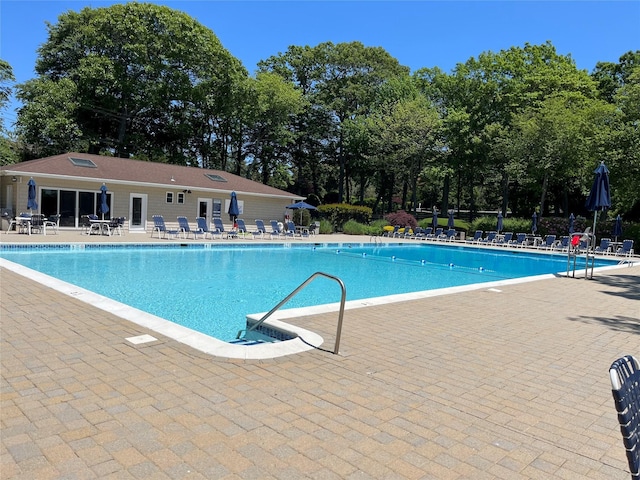 2300 Fox Hill Dr Unit 1101, Baiting Hollow, NY 11933 - community pool with a patio area and view of scattered trees