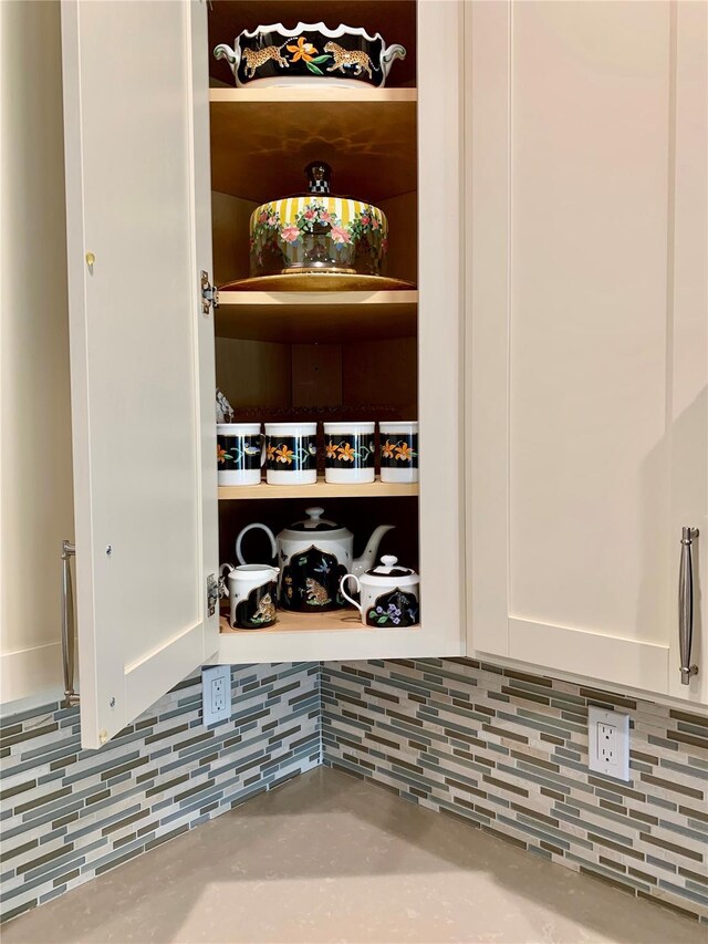 2300 Fox Hill Dr Unit 1101, Baiting Hollow, NY 11933 - kitchen view of white cabinetry, decorative backsplash, and light countertops
