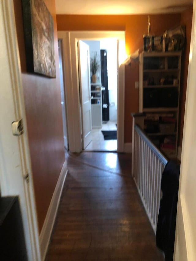 hall with wood finished floors and baseboards