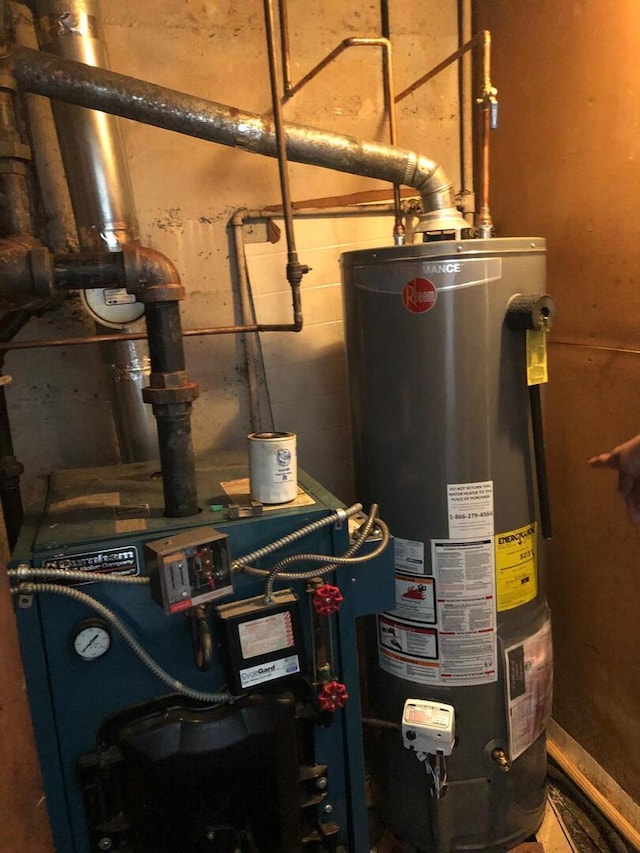 utility room with gas water heater and a heating unit
