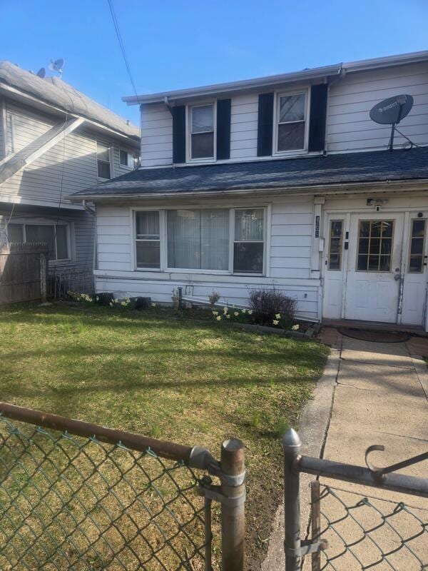 view of front of property with fence and a front yard