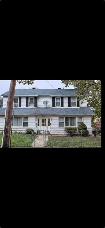 view of front facade with a front yard and a fenced front yard