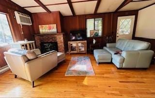 9 Cardiff, Rock Hill, NY 12775 - living area with wooden walls, wood finished floors, a brick fireplace, and a wall mounted air conditioner