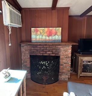 9 Cardiff, Rock Hill, NY 12775 - living area featuring wooden walls, a brick fireplace, and beam ceiling