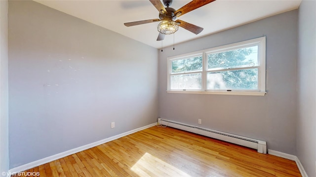 empty room featuring baseboards, a baseboard radiator, a ceiling fan, and light wood-style flooring