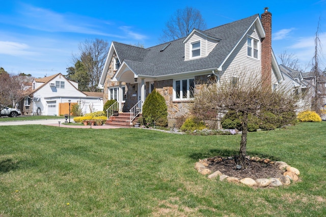 cape cod-style house with stone siding, a front lawn, a chimney, and roof with shingles