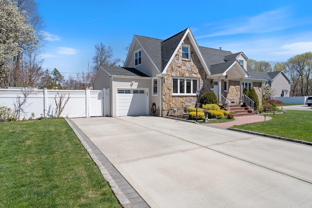 craftsman house featuring a front lawn, stone siding, concrete driveway, fence, and a garage