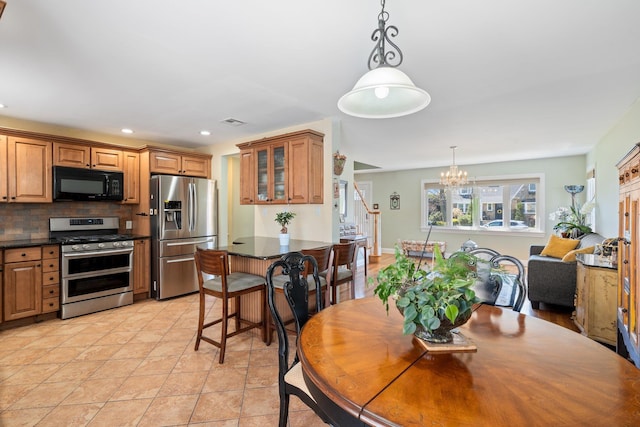dining room with visible vents, an inviting chandelier, recessed lighting, and stairway