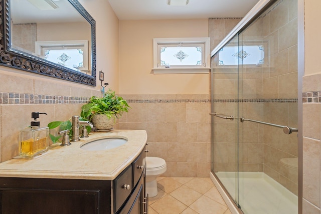 bathroom with toilet, tile walls, tile patterned flooring, and a stall shower