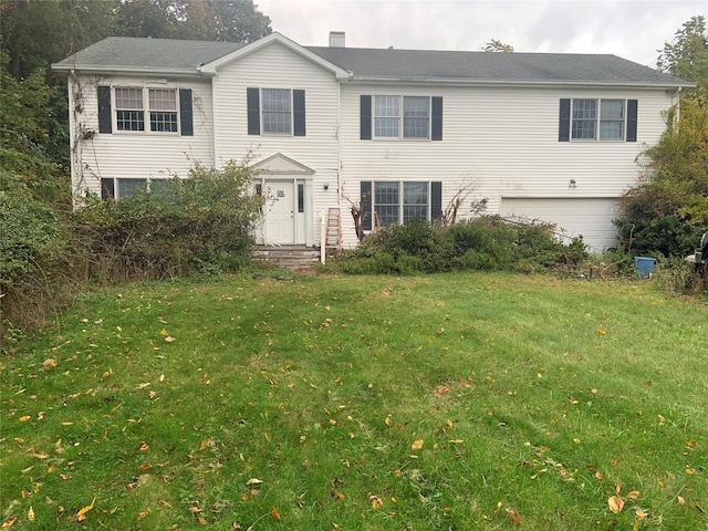 view of front facade featuring a front lawn and an attached garage