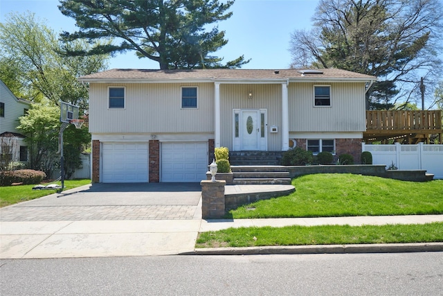1 Neubrech Ct, Jericho, NY 11753 - raised ranch with fence, brick siding, a garage, a front yard, and driveway