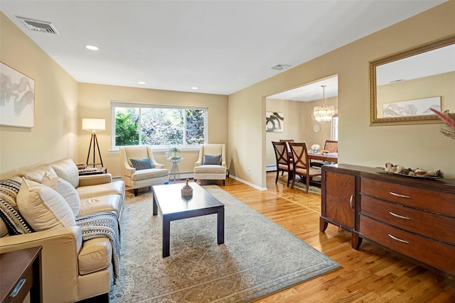 1 Neubrech Ct, Jericho, NY 11753 - living room with a chandelier, visible vents, and light wood finished floors