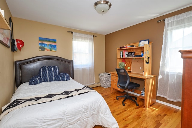 1 Neubrech Ct, Jericho, NY 11753 - bedroom featuring wood finished floors and baseboard heating